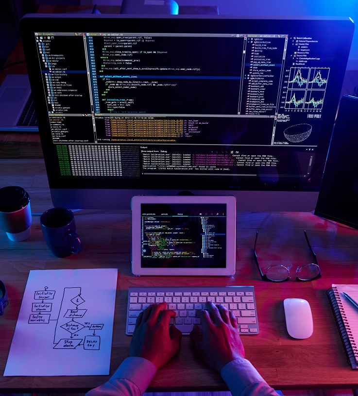 Image of person coding in the dark